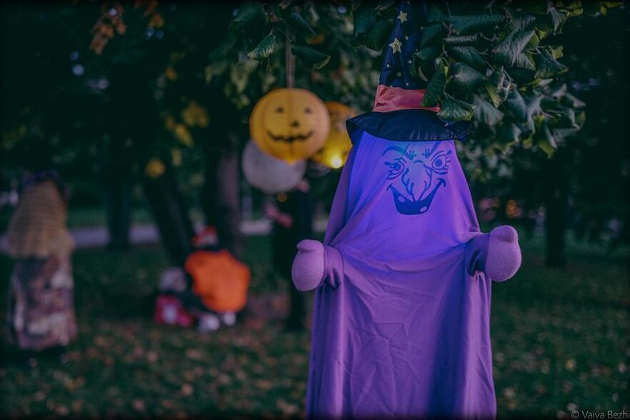 A purple ghost figure among the trees at dusk